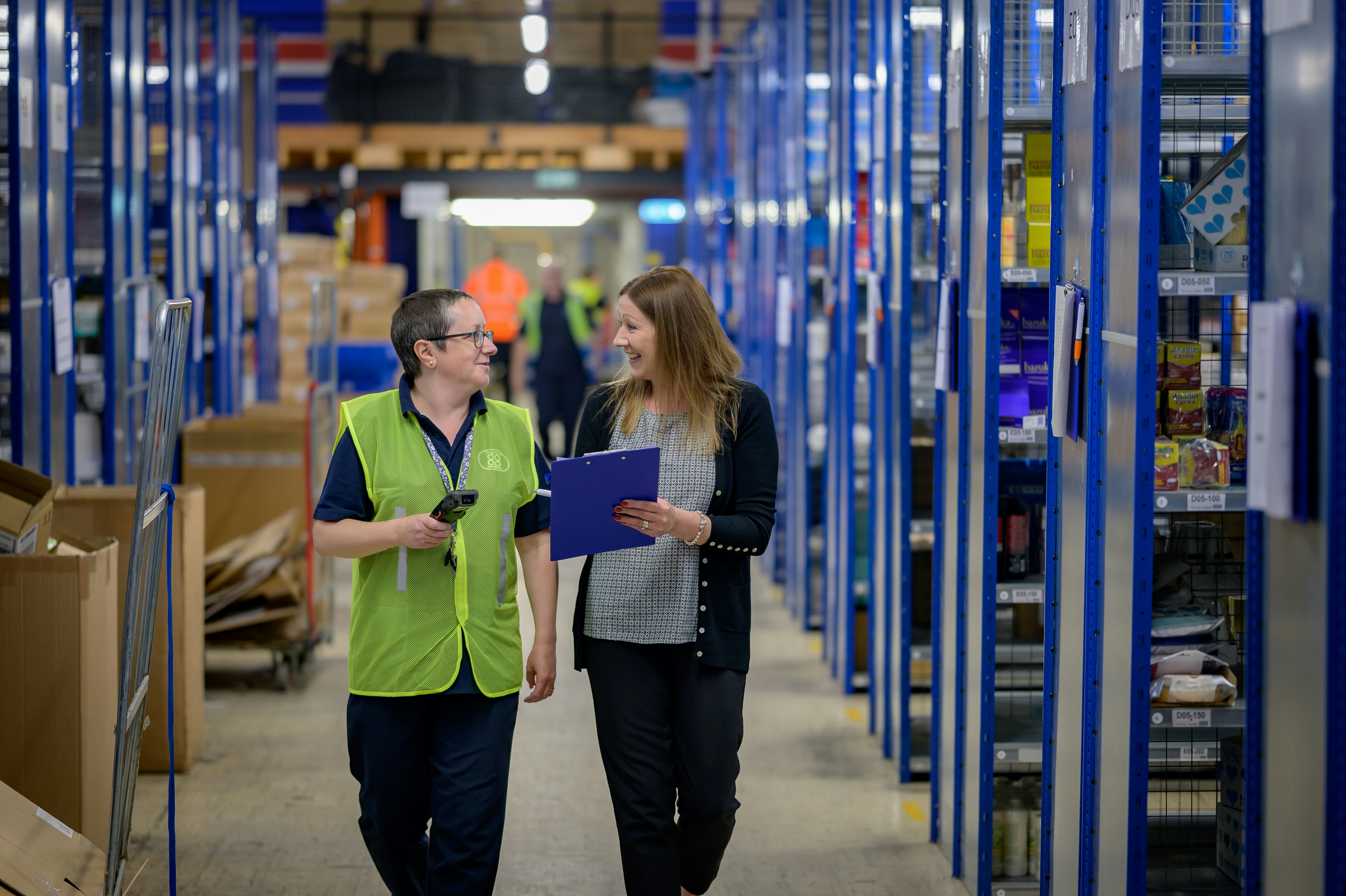 A warehouse worker using a tablet to manage inventory with Zeeta's solution